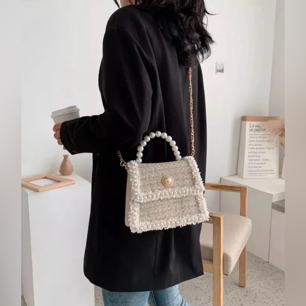 12th Tribe - Small square handbag with pearl trim and a solid gold chain.